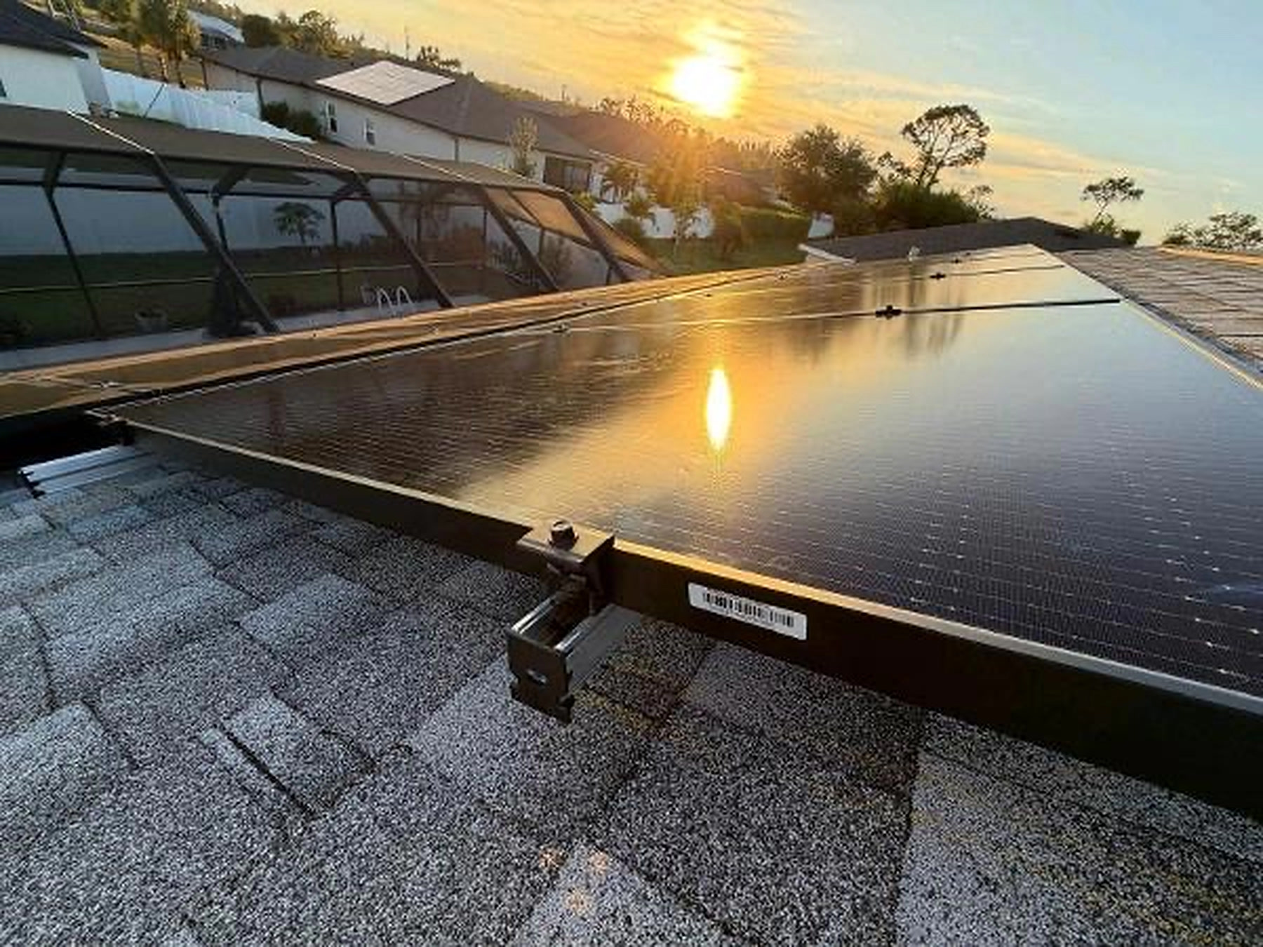 Close-up of solar panel racking and mounting hardware at sunset